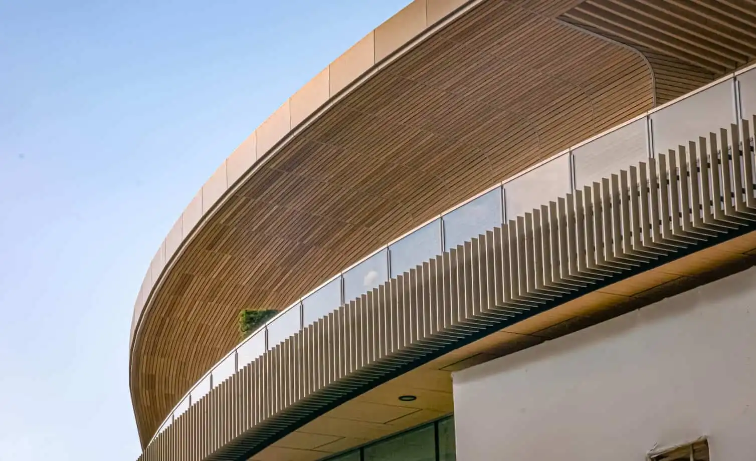 Home 29 Concept Materials Composite Decking Modern building with curved Millboard Cladding Australia design and glass balcony.